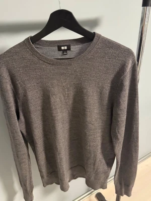 Grå merinoull tröja från Uniqlo - En stilren grå merinoull tröja från Uniqlo, skick 9/10, funkar alltid, perfekt för sommaren och passar till allt, hör gärna av er vid fler frågor eller funderingar, mvh