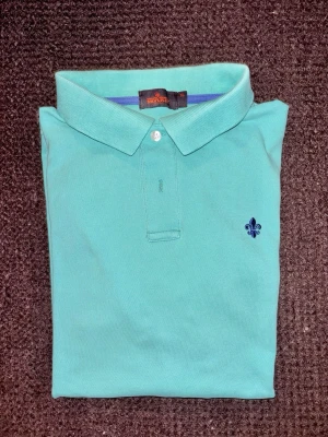 Morris pikétröja - Somrig turkos pikétröja från  Morris i storlek XL.. Något blekt i kragvecket men i fint skick. Från hem utan rök och djur.