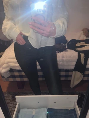 Bruna skinnbyxor - Säljer ett par bruna skinnbyxor med hög midja och tight passform. Materialet har en lätt wet look-känsla som ger en trendig vibe. Perfekta att styla med oversized tröja eller crop top. Supersköna och stretchiga!