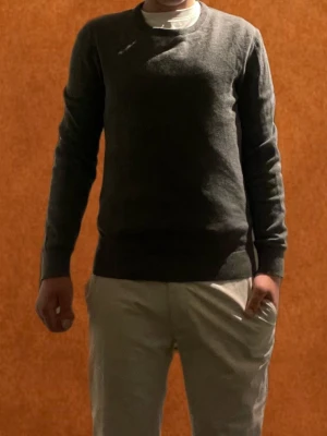 Grå stickad tröja från Pier One  - Säljer En enkel och stilren grå tröja från Pier One med rund hals och långa ärmar. Tröjan har ribbade muddar vid ärmslut och nederkant, vilket ger en snygg passform. Perfekttill många olika grich  outfits nypris 250 mitt pris 100