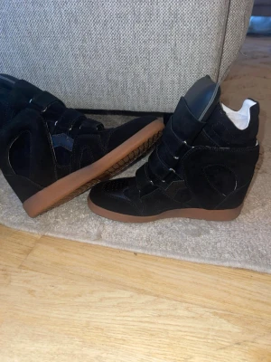 Svarta isabel Marant becket sneakers - Snygga svarta Issabel marant skor i storlek 39, i mycket fint skick nästan som nya. Passar till alla typer av outfits. Säljs då jag behöver pengarna,  först till kvarn🖤