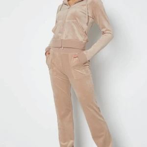 Beige mjukisbyxor i sammet - Supersköna beige mjukisbyxor i mjuk sammet med avslappnad passform och bred resår i midjan. Byxorna har fickor på sidorna och en klassisk look som är perfekt för chill dagar hemma.