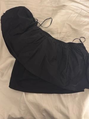 Svart off shoulder topp med volang - Säljer en  svart off shoulder topp med volang från Gina Tricot. Den är kort och är i storlek M.