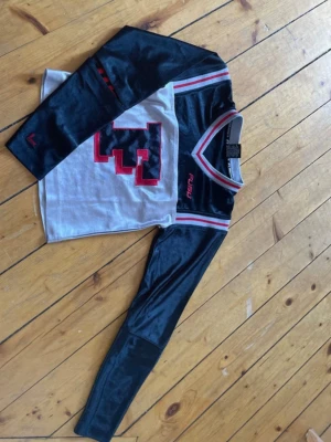 Svart, grå/silvrig och röd långärmad tröja från FUBU FUBU - Cool långärmad tröja från FUBU i svart, grå/silvrigt och röd med stor F framtill