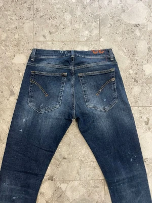 Mörkblå slim fit jeans med slitningar - Dondup Ritchie || Storlek 32 || Jeansen är i bra skick (slitningarna är design ) || Tveka inte på att höra av dig vid frågor eller funderingar 