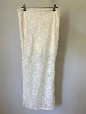 Maxi spetskjol - Säljer en superfin vit spetskjol från Tally Weijl med figurnära passform och transparent spets nedtill ✨ Väldigt trendig och perfekt till sommar, semester, fest eller för en feminin/coquette look. Fint använt skick. Mindre tecken på användning i spetsen/fibrerna finns vid närmare granskning, se sista bild.