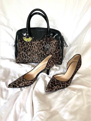 Original handväska + Skor Peter Kaiser - Handväskan är helt i skinn/skinn lack och tyg med leopardmönser. Matchande klackar i storlek 37,5. Supersnyggt nu till sommarens alla outfits! NYPRIS PÅ BÅDE HANDVÄSKA OCH KLACKARNA ligger på 3600 men säljs för 1500