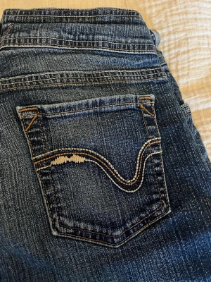 Mörkblå bootcut-jeans - Snygga mörkblå bootcut-jeans från next jeans. Jeansen har en broderad bakficka med vågig detalj som är riktigt snyggt. Köpte från Polen och hittar ej nån storlek tyvärr men skulle nog säga s.