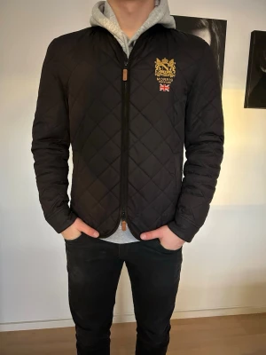  Morris jacka  - Snygg svart jacka med bruna detaljer från Morris i storlek medium. Jackan är i ett grymt sparsamt använt skick utan defekter. 
