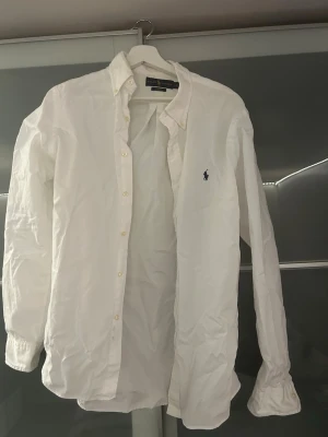 Vit skjorta Ralph Lauren - Klassisk vit skjorta från Ralph Lauren med broderad marinblå logga. Den passar M. 