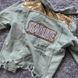 Grön jeansjacka  - Snygg grön jeansjacka med paljetter. Nyskick och köpt på el corte ingles i Spanien, som motsvarar NK. Det står att storleken är L men jag använder xs-s och den sitter bra på mig. Köpt på plick. Bild 2 är tidigare ägarens bild