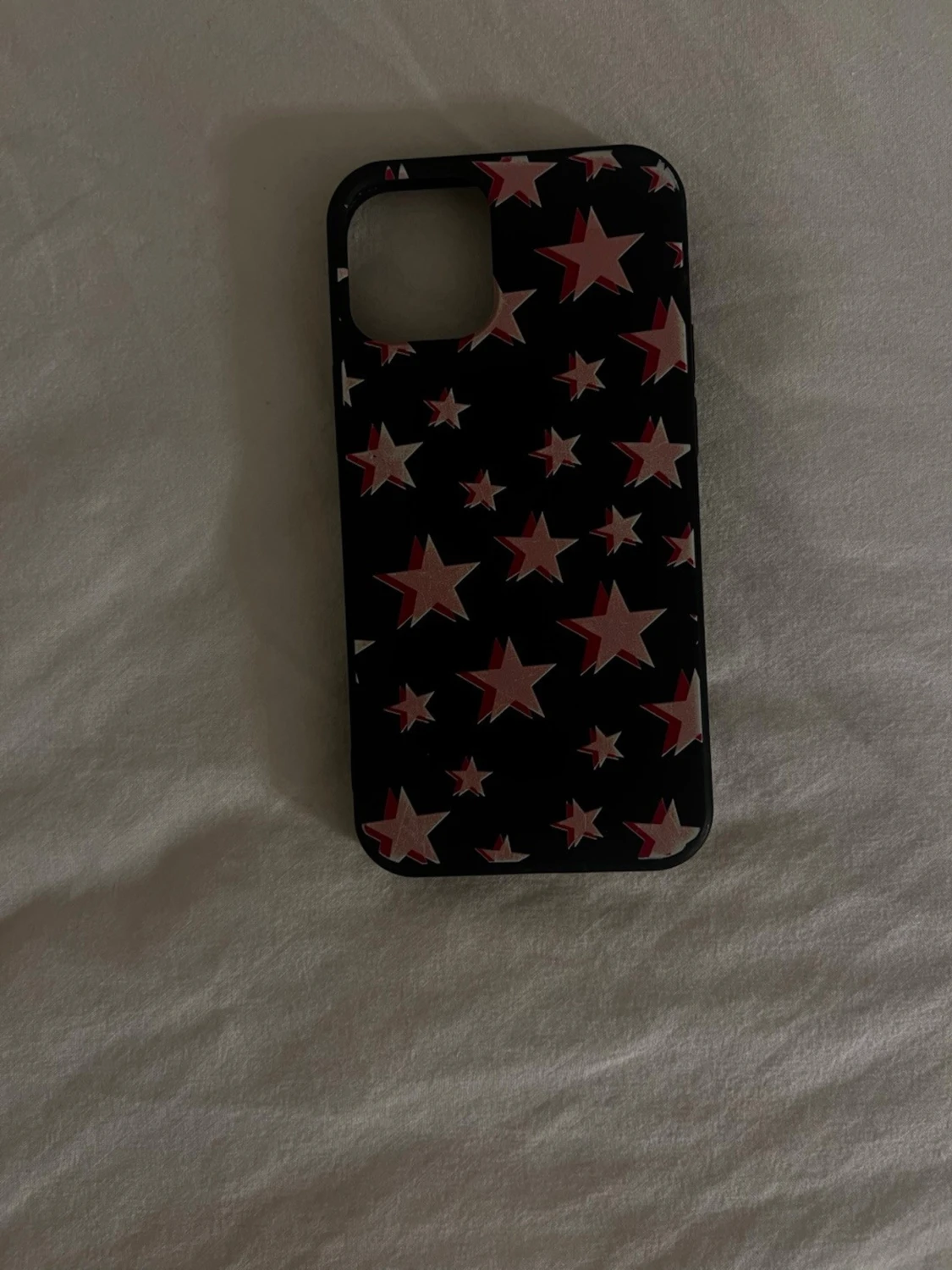 Svart mobilskal med rosa stjärnor