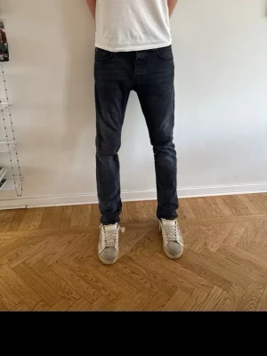 Mörkblå slim fit jeans replay - Säljer ett par mörkblå slim fit jeans med klassisk femficksdesign och normal midja. Jeansen har en snygg tvättad look och smal passform som sitter tajt längs benen. Perfekta för en trendig och avslappnad stil.