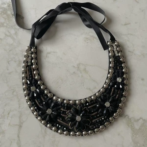 Black Beaded Bib Necklace - Black Beaded Bib Necklace  Felted Bib sits comfortably, Sequin and Black Beading  gently worn  Adjustable Black Ribbon Closure. Best worn with collared shirt.