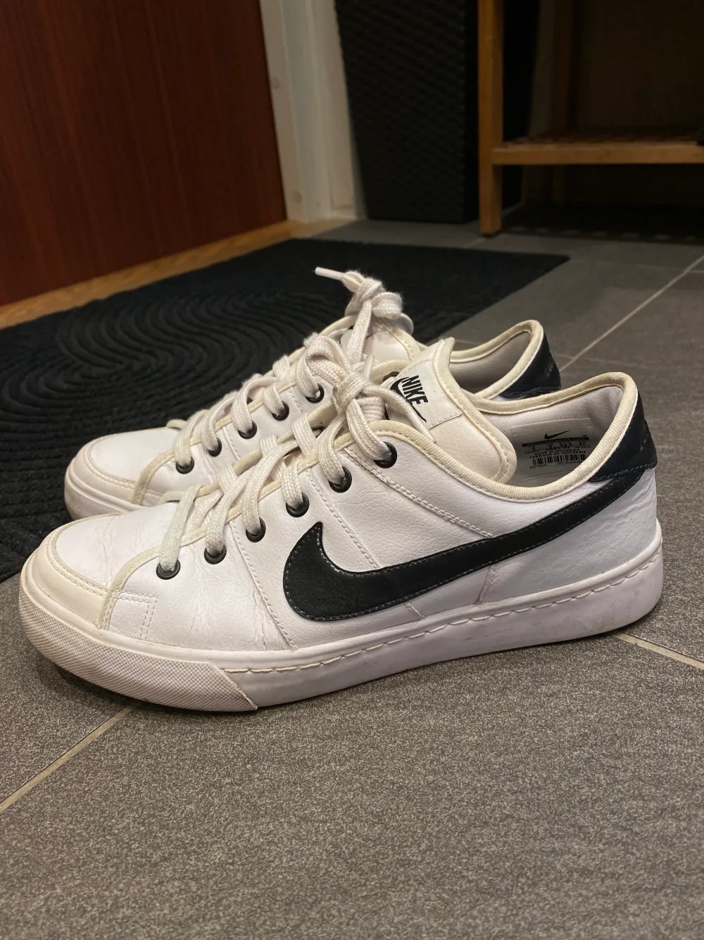 Ett par vita Nike LEGACY skor med svarta detaljer. Säljer dem eftersom att dem är för små för mig. . Skor.