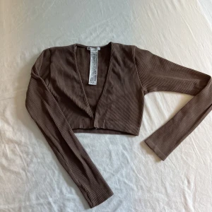 Brun croppad seamless top - En snygg brun croppad seamless top från zara i storlek Xs-s. Passar till lite allt möjligt. Kommer inte till användning därför säljer jag den