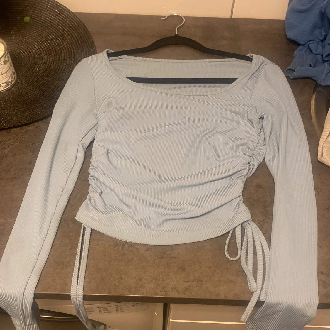 Säljer en blå långärmad tröja med ett knyt vid båda sidorna, väldigt skön att ha på sig och matchar till typ allt