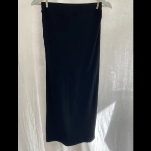 Svart ribbad kjol - Svart ribbad kjol från lager 157. Kjolen är medellång och är i ett ganska tunt material som är väldigt bekvämt.