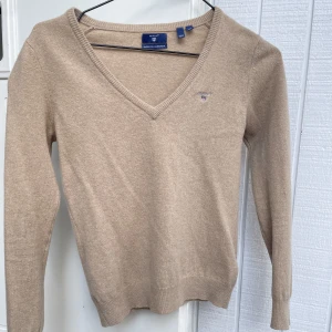 GANT tröja - Säljer en väldigt skön beige GANT tröja som knappt är använd. Perfekt till hösten/vintern🍂❄️ Materialet är 100% ull och inte stickigt utan bara mjukt!