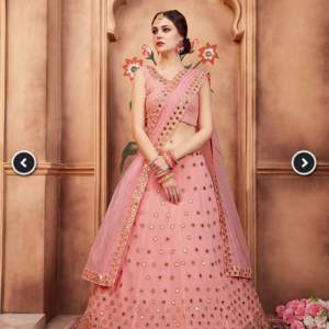 Peach lehenga with net work underneath with blouse and dupatta (scarf)