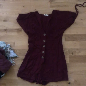One piece play suit  - It’s a small button up playsuite 