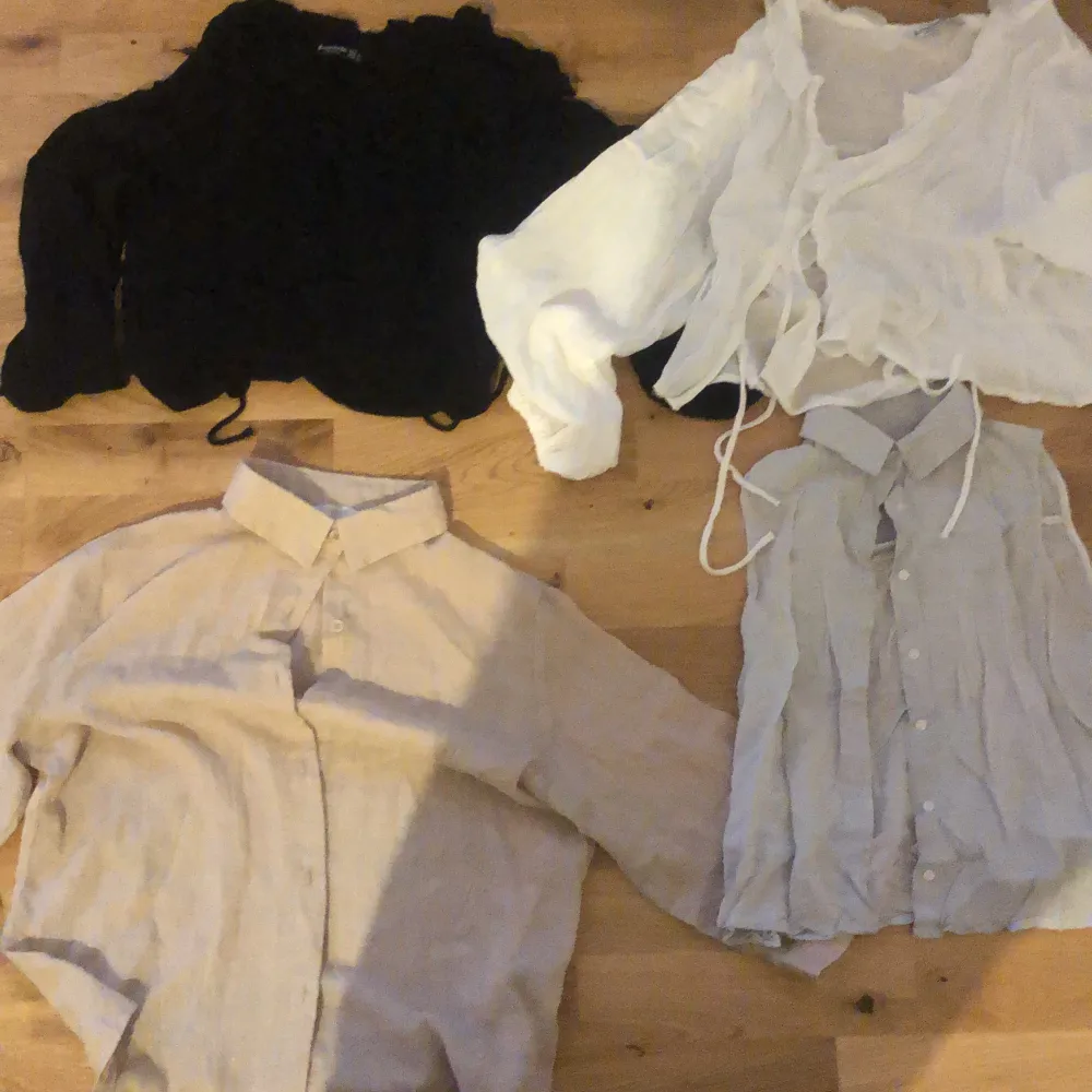 50kr each , blouses , there’s a white and black version of the same blouse that closes with ties in the front, Piet blouse style , one button up linen shirt and one linen vest shirt . Skjortor.