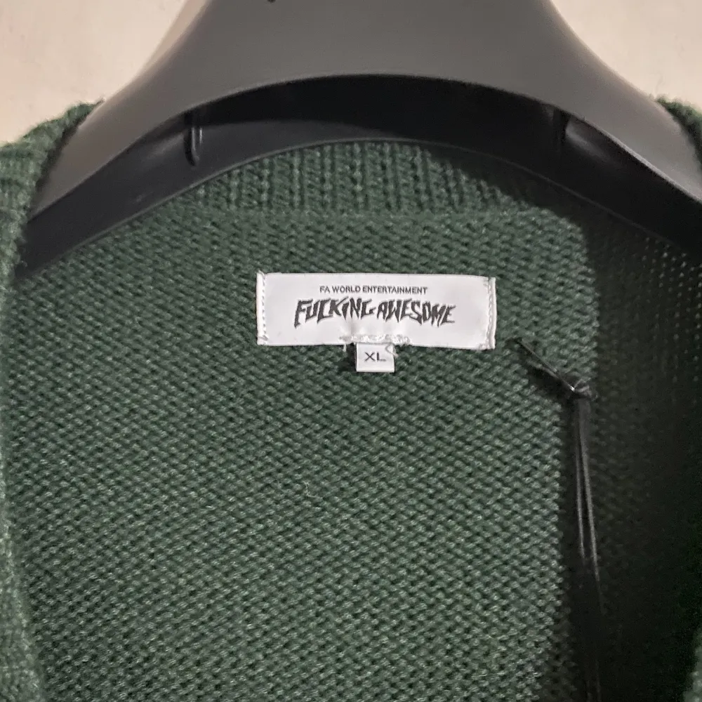 Fucking awesome cardigan XL  Sold out everywhere. Highly sought after piece only worn 2-4 times.  This oversized Fucking Awesome cardigan is knitted from a forest green wool blend. It has small square pockets, one of which is embroidered.. Tröjor & Koftor.