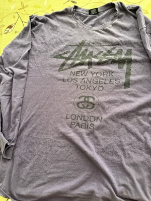 Stüssy World Tour Long Sleeve T-Shirt - Comfortable, roomy, stylish Stüssy long-sleeve tee. Great condition save for two small - easily mendable, if one so wishes - tears around the collar. 100% cotton. Made in Mexico.