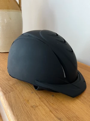 Ridhjälm - Svart ridhjälm storlek M 55-58. Använd 10 gånger. Denna kan hämtas i Tyresö, Stockholm.
