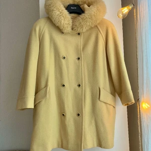 Vintage jacka med luva - Min älsklingsjacka! Gul filtkappa med stor gosig pälsluva. Jackan går till lite över knäna på mig som är 165 cm. En perfekt sexig oversized vinterjacka!