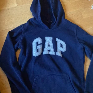 Gap Luvtröja. XS  - Har en luvtröja här. Är använd. Marinblå. Fullt fungerande till nån mera. 
