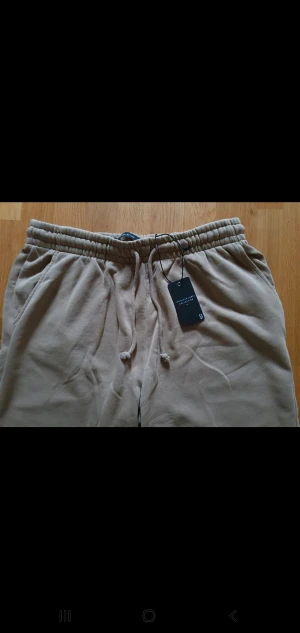 Byxor - Oanvända byxor. Nyskick. Säljes pga korta i längden.  89 cm i längd 55 cm bredd