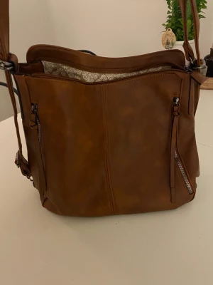 Oanvänd brun skinnväska (oäkta) - Stor och rymlig axelremsväska. Oanvänd då väskan var lite för stor för mitt tycke. 