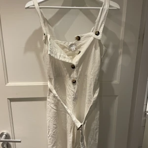 Vit jumpsuit  - Jättefin vit jumpsuit från topshop med bruna knappar samt bälte runt midjan som går att ta av helt.✨