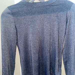 Glittrig tröja  - Säljer en glittrig tröja ifrån tommy hilfigher och är i storlek 140 men jag är 163 och den sitter väldigt bra 💕