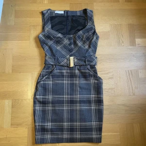 Rutig klänning - En proper rutig klänning med pencil fit 💙 Går ner lite under knäna, köpt secondhand men i prima skick. Ger lite viv westwood vibbar 🤩