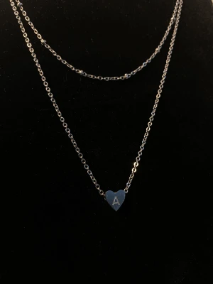 Halsband med hjärta och bokstaven A - Ett halsband med bokstaven A. De är ett dubbel halsband med lite små pärlor på