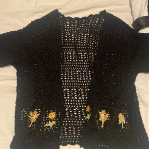 Kofta - En jätte fin virkad kofta med hål i och blommor ner till dem är jätte fin det finns direkt ingen storlek men skulle säga runt xs och s