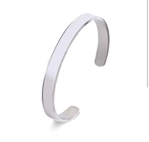 SILVERFÄRGAT ARMBAND - Manschettarmbandet är tillverkat i rostfritt stål. Det silverfärgade armbandet är öppet i båda ändar för att enkelt kunna tas på.