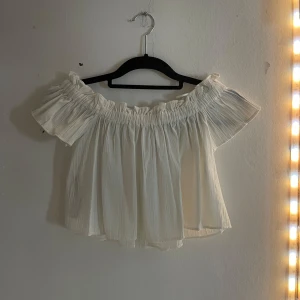 Vit offshoulder blus  - Säljer en söt vit offshoulder blus från berskha . Blusen har en luftig passform med elastisk kant runt axlarna för en bekväm och stilren look. Perfekt för varma dagar eller sommarens fester. 🌸