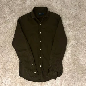 Olivgrön linneskjorta från Polo Ralph Lauren - Säljer en olivgrön linneskjorta från Polo Ralph Lauren i slim fit | Skjortan är i lite tjockare linne så passar på kyligare dagar | Storlek: S | Skjortan är grön/brun/olivgrön