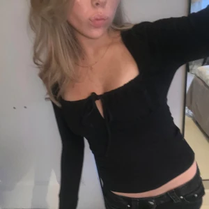 svart långärmad med knyt - svart thight, långärmad topp från gina tricot.  Den har en djupare urringning med knyt som gör att den passar till både fest och vardag. 