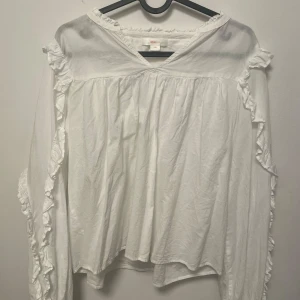 vit blus från Gina med volang på armarna - en ny blus använd max 2 gånger helt bra skick