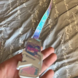 Holografiskt bälte med silverdetaljer - Säljer ett coolt holografiskt bälte med stora silverdetaljer och spänne. Bältet har en skimrande yta i regnbågsfärger och är perfekt för att ge outfiten en unik touch.