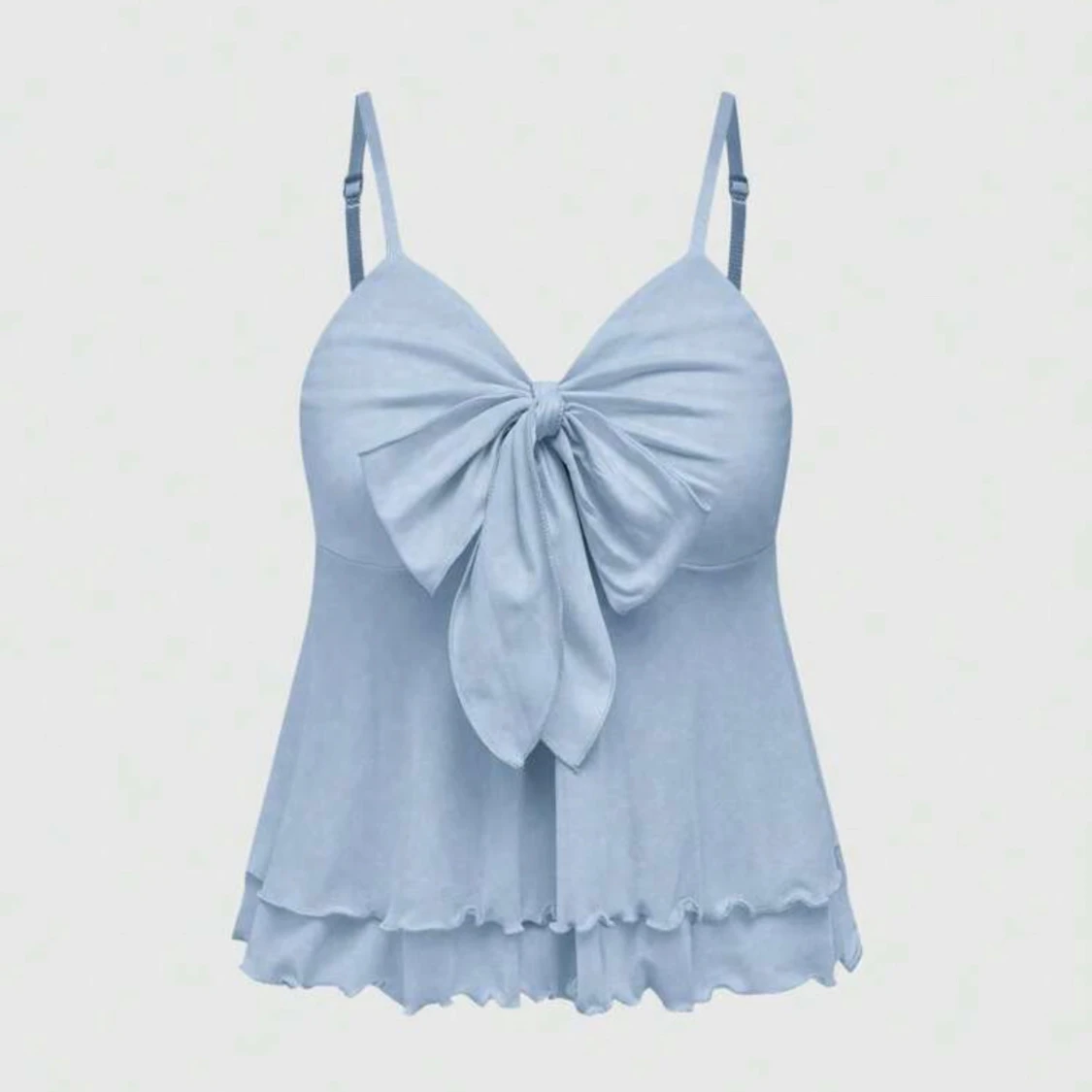 Ljusblå topp med rosett