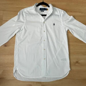 Slimfit skjorta Polo Ralph Lauren - Vit Slim fit Polo Ralph Lauren skjorta I 100% cotton | Nyskick, autentisk/äkta | Skick 9,5/10 | Stl 16 år, passar 165 ungefär/Xs | Fin till sommaren 🔥| Skriv för bilder eller frågor | 