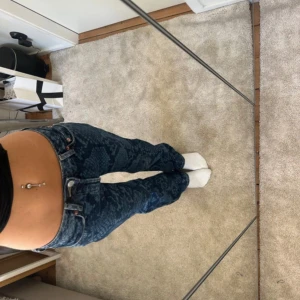 Mönstrade jeansbyxor från Weekday - Säljer ett par blå jeansbyxor från Weekday med unikt mönster Byxorna har normal passform, klassiska fickor och låg midja. Säljer då dem va försmå för mig, köpta från vinted. Bilderna är inte mina men kan skriva för egna bilder. Pris kan diskuteras 🩷