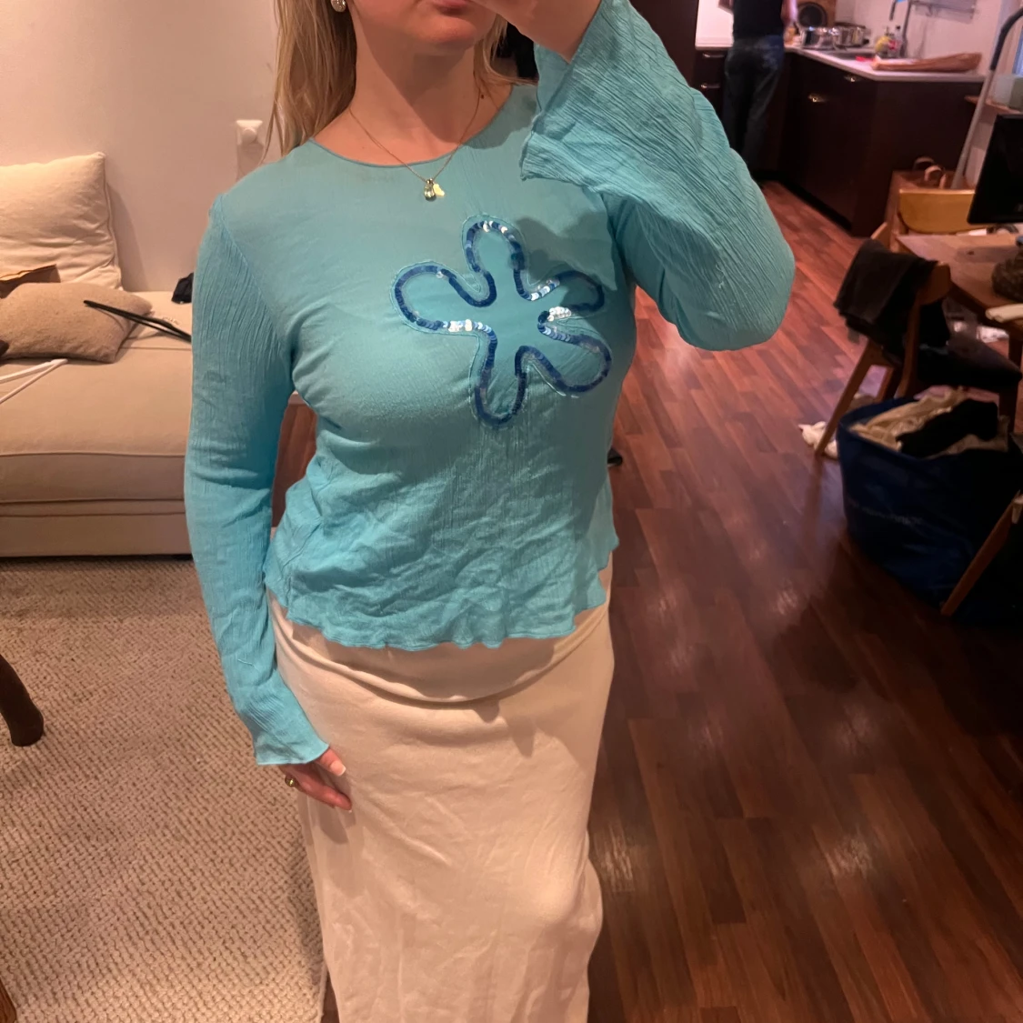 Turkos långärmad topp med paljettblomma