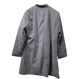 Grå kappa från Flex Supply, stl L - Snygg grå kappa från Flex Supply i storlek L. Jackan har en stilren och rak passform med långa ärmar och är tillverkad i en mjuk blandning av polyester och bomull. Perfekt för dig som gillar minimalistisk och clean stil.