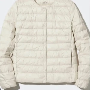 Vit dunjacka från Uniqlo - Säljer en stilren vit dunjacka från Uniqlo. Jackan har en quiltad design och långa ärmar. Skriv för bilder och mer info.